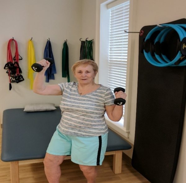 female resident using hand weights