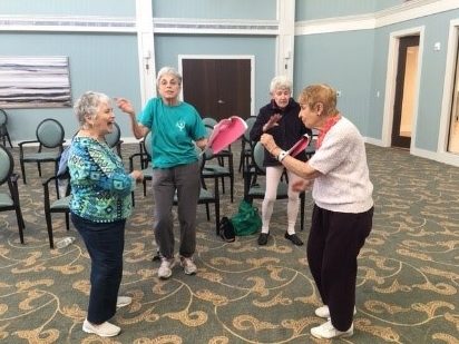 4 female seniors dancing