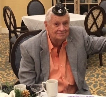 man being silly with tiny hat on head